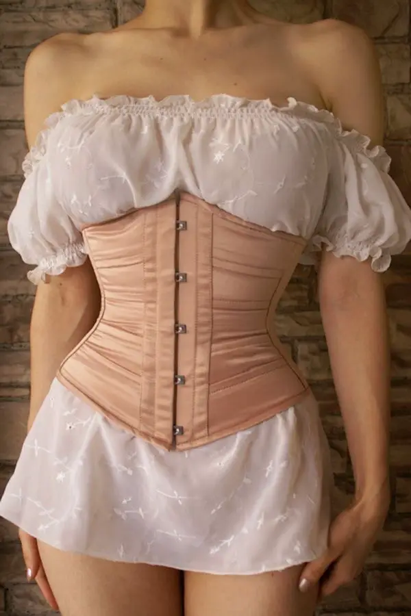 Light brown corset over a short off white dress